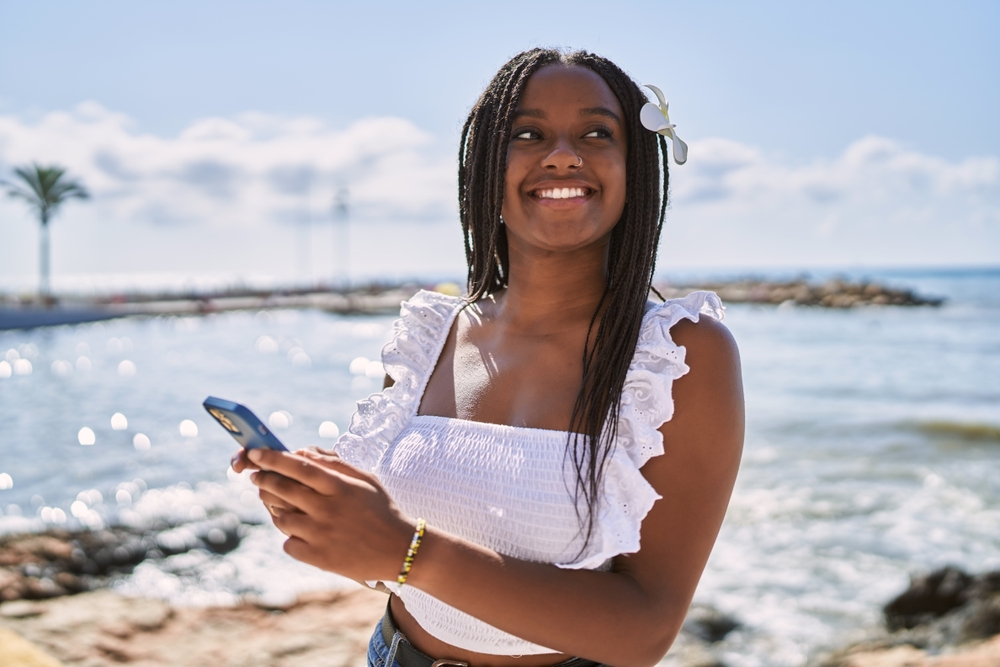 A guest on her phone after arriving, ready to look at nearby experiences